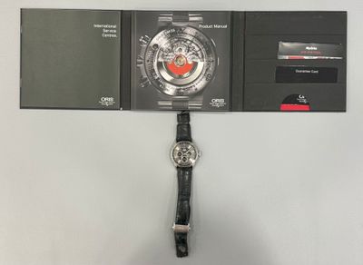 a watch that is hanging on a wall next to a wallet
