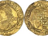 a gold coin with an image of a man holding a sword
