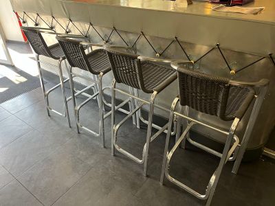 a lot of chairs that are sitting at the bar