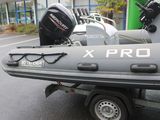 a small boat parked in a parking lot next to a building