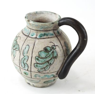 a vase with a handle that has a frog on it