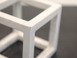 a small white object on a table with a black surface