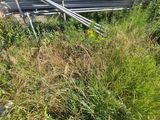 a pile of metal pipes sitting in the grass