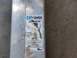 a metal box with a sticker on it sitting on the ground