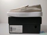 chaussures à enfiler pour homme, couleur beige, à semelles blanches, présentées sur un carton noir