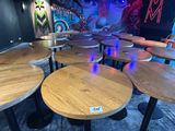 tables and stools are lined up in a room with a mural on the wall