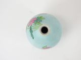 a small blue vase with a flower design on it