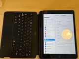 two laptops sitting next to each other on a table