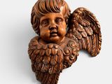 a close up of a small statue of an angel on a white background