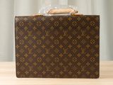 an image of a louis vuitton briefcase sitting on a table