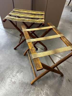 two wooden folding stools sitting next to each other in a room