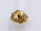 a close up of a gold ring on a clear ring holder