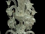 a glass chandelier that is hanging from the ceiling