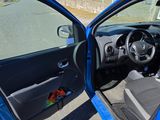 a blue car with its door open on the street