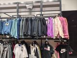 a lot of clothes hanging on a rack in a store