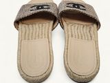 the slippers are made of woven fabric and have a black eye on them
