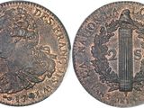 a coin with an image of a woman and a sword on it