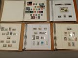 several different types of stamps are displayed in a binder on a table