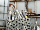 a pile of metal pipes sitting on top of a pallet