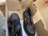 two pairs of shoes in a box on the floor