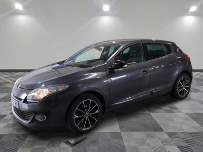 a grey car is parked in a room with a checkered floor
