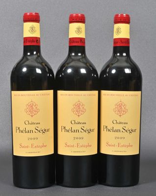 three bottles of red wine sitting on top of a table