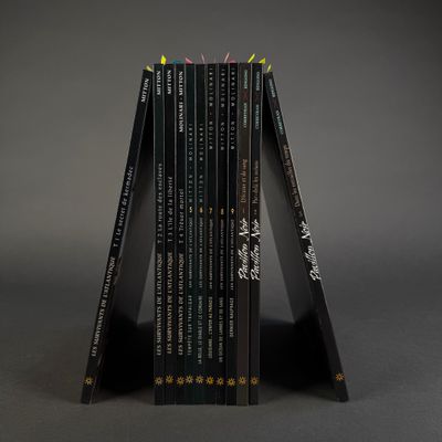 books stacked on top of each other on a gray surface