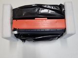 a close up of a black and orange printer unit on a white surface