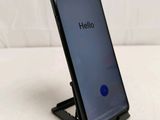 a close up of a cell phone on a stand on a table