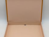an open cardboard box on a white surface with a white background