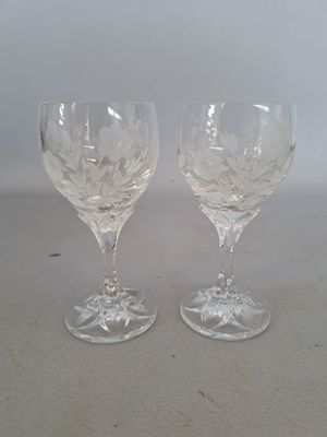 two wine glasses that are sitting on a table