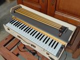 a piano that is sitting on a stand in a room