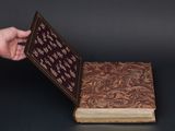 someone is holding a book open to show a pattern on it