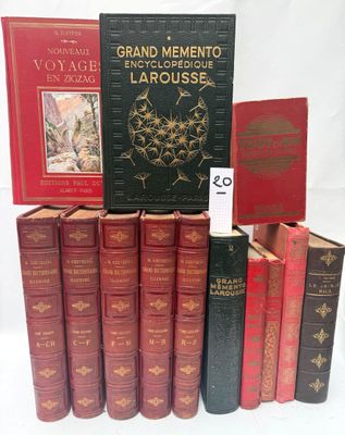 several books are stacked on top of each other on a white surface