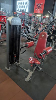 a gym with a lot of machines in the room