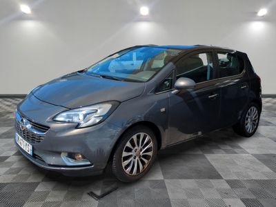 the grey car is parked on a checkered floor in a garage