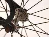 a close up view of a bicycle wheel with spokes