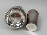 silver plated salt and pepper shakers on a white surface