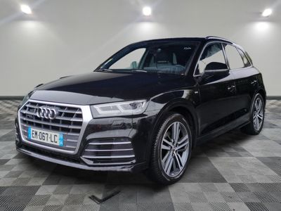 a black audi suv parked in a garage with a checkered floor