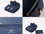 a close up of a blue purse with a gold clasp