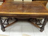 a wooden table with four chairs around it in a room