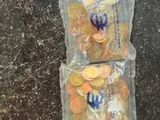 two bags filled with coins sitting on a counter