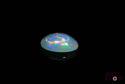 an image of a white oplite in the dark
