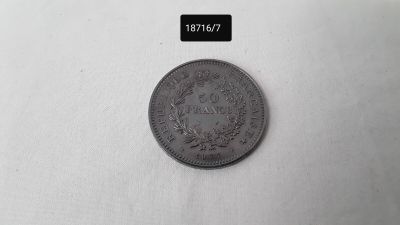 a close up of a coin on a white surface