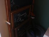 a blackboard on the wall next to a trash can