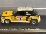 a toy car in a display case on a table