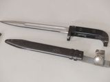 two knives and a watch on a table