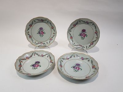 three plates with floral designs are sitting on a white surface