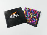 two small black bags with colorful ribbons on them on a white surface