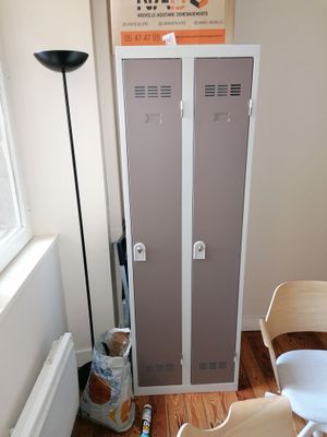 a chair and a table in a room with two lockers